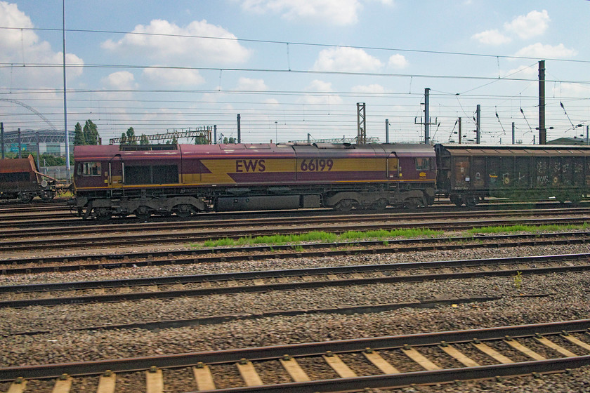 66199, 07.07 Dollands Moor-DIRFT (6M44), Wembley Yard 
 66199 sits at the north end of Wembley yard with the 07.07 Dollands Moor to Daventry empty cargo vans. This has a fairly long layover in Wembley Yard before heading up to Northamptonshire to disgorge its bottled water. 
 Keywords: 66199 6M44 Wembley Yard