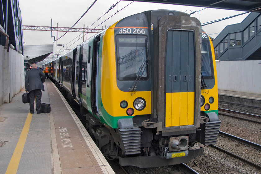 350266, LM 10.13 London Euston-Birmingham New Street, Northampton station 
 350266 waits at Northampton's platform two ready to continue onwards as the 10.13 Euston to Birmingham New Street. My wife and I took this train to its Midland's destination. Notice the new footbridge as part of the wider station re-build still shrowded in protective hoardings. 
 Keywords: 350266 10.13 London Euston-Birmingham New Street Northampton station Desiro London Midland