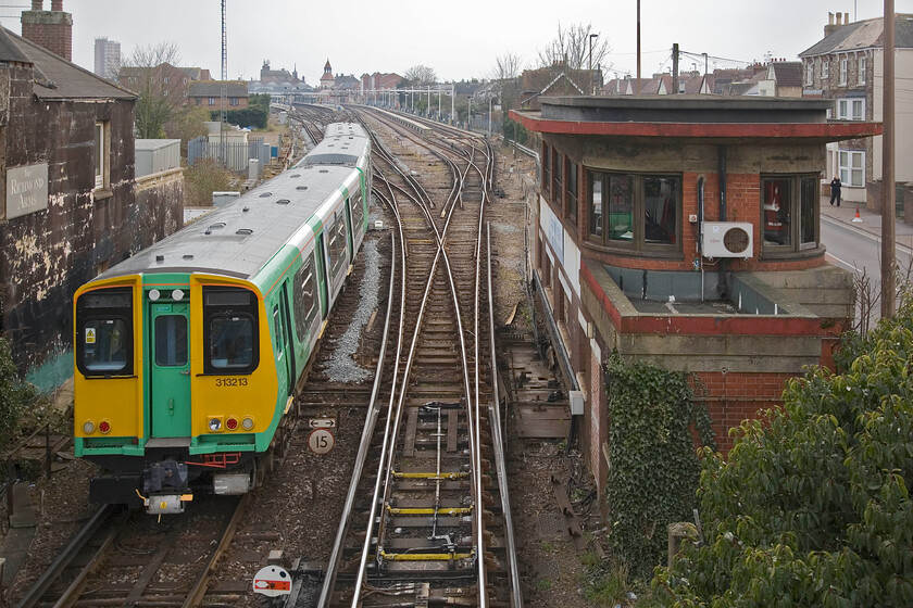 313213, SN 15.53 Barnham-Bognor Regis, London Road footbridge, Bognor Regis 
 The 15.53 Barnham to Bogor Regis service approaches its destination worked by 313213. Whilst the platforms at Bognor are long enough harking back to the days when seaside excursions would have been accommodated with the servicing platforms to the right being even longer. These are used in the night to perform light servicing and cleaning of units ready to go out in the morning heading, largely towards London. The superb Southern Type 13 signal box seen to the right was built in 1938 and is still in full operation today; but for how long I wonder before Network Rail re-signals the area. 
 Keywords: 313213 15.53 Barnham-Bognor Regis, London Road footbridge, Bognor Regis.jpg