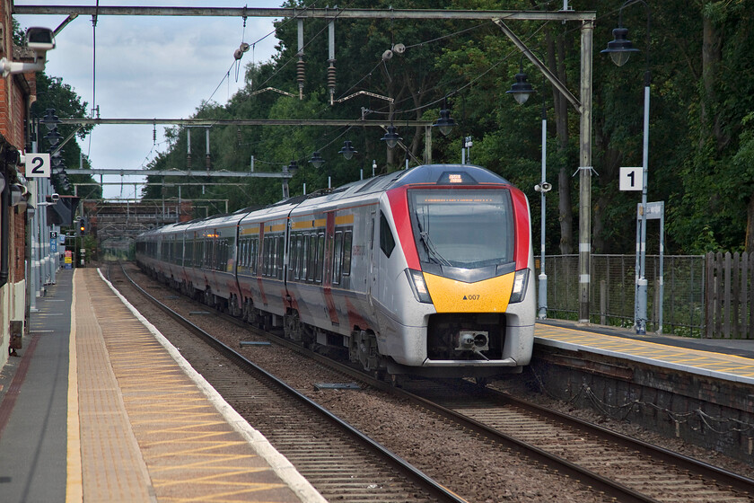 745007, GA 13.00 Norwich-London Liverpool Street (1P39, 3L), Ingatestone station 
 Ingatestone station is located some twenty-three miles from London and during 'non-COVID' times is extremely busy with commuters. The present station building (to the immediate left in this photograph) was opened in 1844 built to a reproduction Tudor style with diaper brickwork. Stadler built 745007 passes the station at line speed with the 13.00 Norwich to Liverpool Street 1P39 Greater Anglia service. Until recent times this service would have been a rake of rather tired Mk. II coaches hauled by a Class 90 with the customary DVT at the country end. 
 Keywords: 745007 13.00 Norwich-London Liverpool Street 1P39 Ingatestone station Stadlen Great Anglia