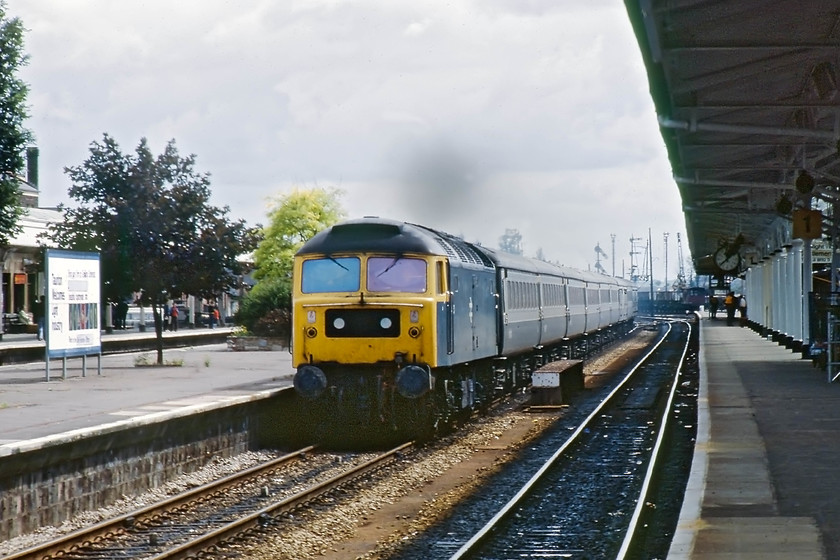 47001, unidentified down working, Taunton station 
 47001 takes the middle down road through Taunton station with an unidentified working. At this stage, Taunton boasted two large signal boxes, both of GWR Type 11 design. They were Taunton West and East, formally East Junction. There was also Taunton West Junction that closed in the early 1970s, it was located just east of the Staplegrove Road bridge. The central island platform at Taunton was very rarely used at this time with large wooden padlocked doors preventing access from the pedestrian tunnel that linked all the platforms. 
 Keywords: 47001 unidentified down working Taunton station