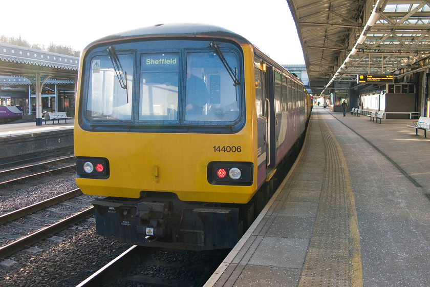 144006, NT 09.06 Sheffield-Leeds (2L18), Sheffield station 
 Time for some Pacer action at Sheffield! 144006 waits to leave with the 2L18 09.06 working to Leeds that we would travel on as far as Woodlesford. Not a very quick service that stopped at every station travelling via Barnsley, Wakefield Kirkgate followed by a reversal at Castleford. On a cold morning such as this, the heating struggled to keep the train warm with all the drafts from the doors and windows. Having done thirty years of service, it really it is time was called on these units! 
 Keywords: 144006 09.06 Sheffield-Leeds 2L18 Sheffield station