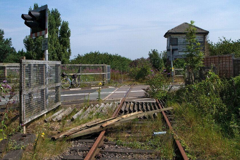 Trackbed looking NE & Fosseway crossing SK100079 
 No more trains will ever be likely to cross Fosseway level crossing as seen here and be signalled by the 1875 LNWR box. It is pretty astounding that the box has not succumbed to the vandals and been burnt down! 
 Keywords: Trackbed looking NE & Fossway crossing SK100079