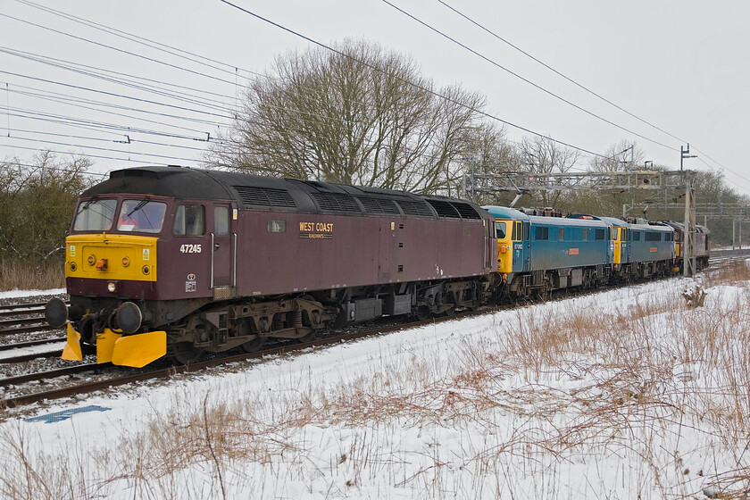 47245, 87002, 86101 & 33029, Carlisle-Southall LEs, Roade 
 An interesting lash-up of locomotives pass just south of Roade in the form of 47245, 87002 'Royal Sovereign', 86101 'Sir William A Stanier FRS' and 33029 'Glen Loy'. The train had run down from Carlisle heading for Willesden for exam. purposes retrurning the same day in order to stable the two AC electrics back at Carlise as part of this winter's Ice Maiden standby duties for Network Rail. 
 Keywords: 474245 87002 86101 33029 Carlisle-Southall LEs Roade Royal Sovereign Glen Loy