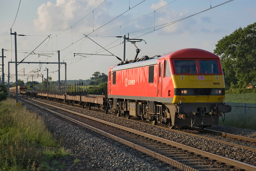 90029, 16.31 Garston-Dagenham (6L48), Milton Malsor SP740553 
 Notice the ominous cloud gathering in the northeastern sky! However, this has not stopped the evening light from the midsummer sun behind me spoiling the image. 90029 looks very smart in its DB Schenker livery as it passes Milton Malsor leading the 6L48 16.31 Garston to Dagenham empty car transporter train. The previous day this will have worked north carrying various Ford products to the company's finishing and distribution centre. 
 Keywords: 90029 16.31 Garston-Dagenham 6L48 Milton Malsor SP740553