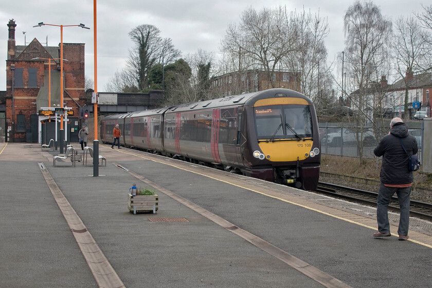 170108, XC 09.15 Leicester-Birmingham New Street (1P08, 1L), Water Orton station 
 The 09.15 Leicester to Birmingham stopper service arrives at Water Orton station formed by 170108. The station currently gets an hourly service sandwiched in between various other non-stop passenger and freight services. Notice my blue mug on the planter. The remnants of the coffee were stone cold now so it was definitely time that Andy and I walked back to his car and found some breakfast! However, as is often the case, there was just one more train to wait for........ 
 Keywords: 170108 XC 09.15 Leicester-Birmingham New Street 1P08 Water Orton station CrossCountry Turbostar