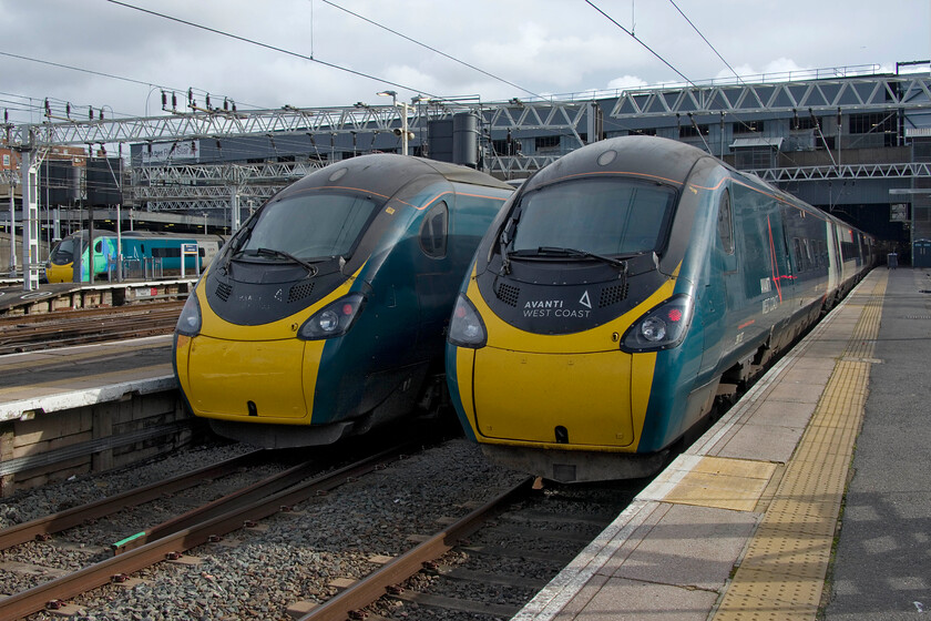 390121, VT 13.16 London Euston-Glasgow Central (9S77, RT), 390152, VT 13.40 London Euston-Birmingham New Street (9G24, RT) & 390137, VT 13.53 London Euston-Manchester Piccadilly (1H24, 4L), London Euston station 
 Three Pendolinos are seen in the daylight outside of the dark and oppressive interior of Euston station. To the extreme left, 390121 'Opportunity' is instantly recognisable by its unique livery with 390152 in the middle and 390137 nearest the camera. The three services are the 13.16 to Glasgow central (9S77), the 13.40 to Birmingham (9G24) and finally the 13.53 to Manchester (1H24). 
 Keywords: 390121 13.16 London Euston-Glasgow Central 9S77 390152 13.40 London Euston-Birmingham New Street 9G24 390137 13.53 London Euston-Manchester Piccadilly 1H24 London Euston station Avanti West Coast Pendolino Opportunity