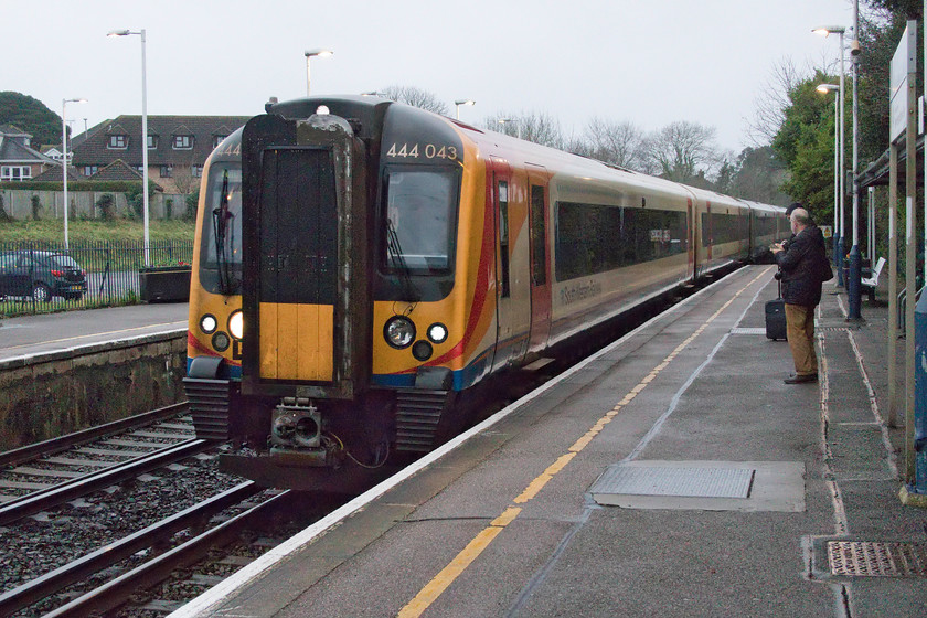 444043, SW 14.20 Weymouth-London Waterloo (1W64, 1L), New Milton station 
 Andy eagerly collects the coach numbers from SWR's 444043 as it slows for its stop at New Milton station. In the dreadful afternoon light it is working the 14.20 Weymouth to Waterloo. 
 Keywords: 444043 14.20 Weymouth-London Waterloo 1W64 New Milton station South Western Railway SWR