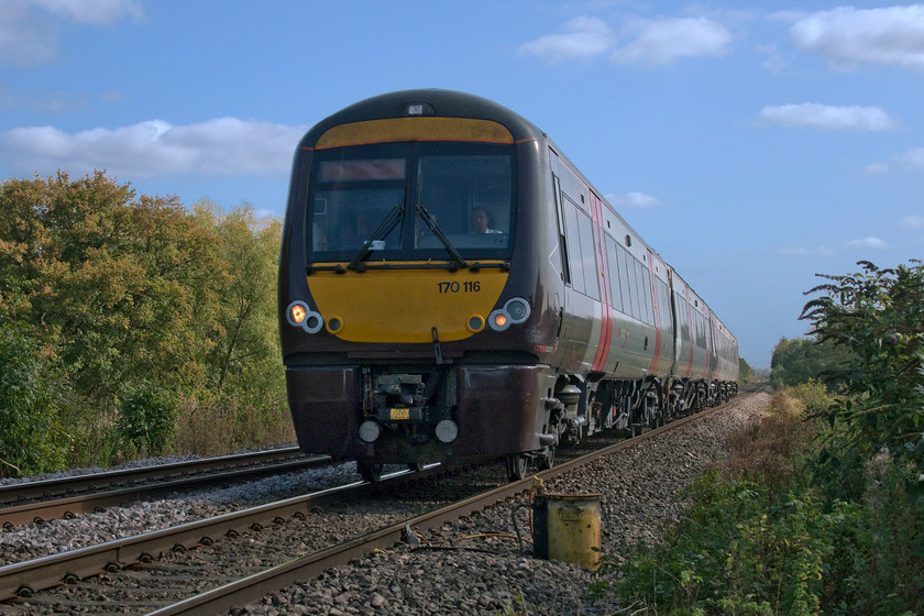 170116, XC 13.00 Cambridge-Birmingham New Street (1N55, 1L), Wymondham crossing 
 170116 works the 13.00 Cambridge to Birmingham New Street on the approach to Wymondham level crossing. After a long section of straight track from Oakham, the train will then take the curiously named Lord Harborough's Curve taking the line westwards again towards Melton Mowbray. This sharp curve, even less so now after the Midland and Great Northern Joint Railway realigned it, was as a result of the refusal of the then landowner, the sixth Earl of Harborough, to allow the line through his land and to partially take the alignment of the Oakham Canal of which he was a shareholder. 
 Keywords: 170116 13.00 Cambridge-Birmingham New Street 1N55 Wymondham crossing CrossCountry XC