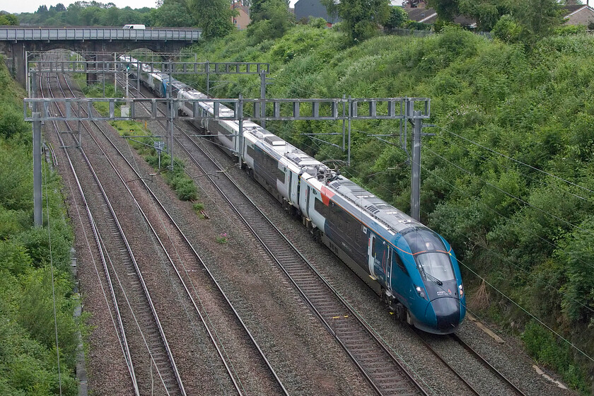 805008 & 805003, VT 17.02 London Euston-Holyhead (1D91, 54L), Hyde Road bridge 
 With the new summer timetable having come into operation two days previously the much-awaited Class 805s have begun revenue-earning service meaning that the Class 221s can be moved on to another operator. Looking smart and fresh 805008 and 805003 work the late running 1D91 17.02 Euston to Chester service through Roade. Unfortunately, everything was working late on this day including this service following a complete OLE power supply failure at Euston during the morning. 
 Keywords: 805008 805003 17.02 London Euston-Holyhead 1D91 Hyde Road bridge