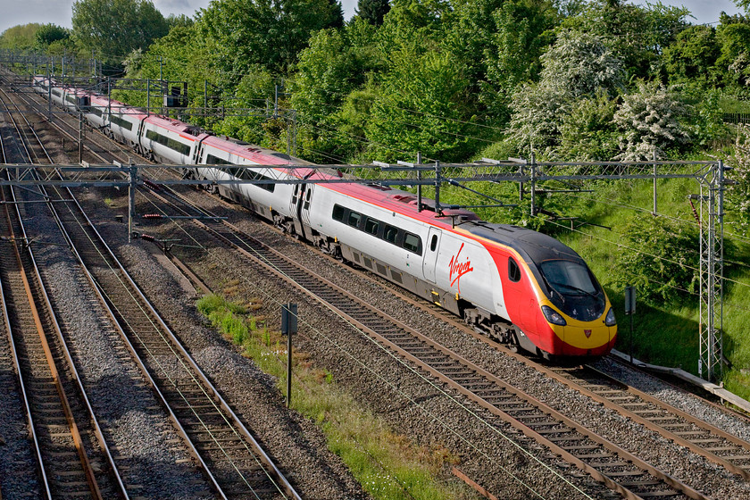 390044, VT 07.30 London Euston-Preston (1S42), Victoria bridge 
 Looking very smart in the early morning sunshine, 390044 races past Victoria bridge between Milton Keynes and Rugby working the 1S42 07.30 Euston to Preston. Note that the service has the 'S' reporting number indicating its destination as Scotland. For us southerners, the Lancashire town of Preston certainly feels that it's near to Scotland but geographically it is still firmly in England! 
 Keywords: 390044 07.30 London Euston-Preston 1S42 Victoria bridge Virgin Trains Pendolino