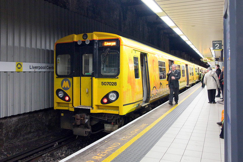 507028, ME 16.20 Liverpool Central-Kirby (2K39), Liverpool Central station 
 Down in the depths of Liverpool Central station, the driver of 507028 walks up to his cab in order for the train to leave in a few minutes with the 16.20 to Kirby. 
 Keywords: 507028 16.20 Liverpool Central-Kirby 2K39 Liverpool Central station