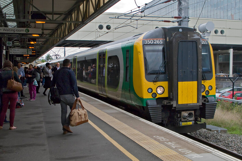 350235, LM 10.54 Birmingham New Street-London Euston (12.22 Milton Keynes Central-Watford Junction) (2Y06), Milton Keynes Central station 
 The 10.54 Birmingham New Street to Euston arrives at a very crowded Milton Keynes station. I travelled on this extremely busy service as far as Watford Junction alighting there as it was not at all clear as to how far the London Midland service would get towards Euston before being terminated due to an operational incident close to the station. 
 Keywords: 350235 10.54 Birmingham New Street-London Euston 2Y06 Milton Keynes Central station London Midland Desiro