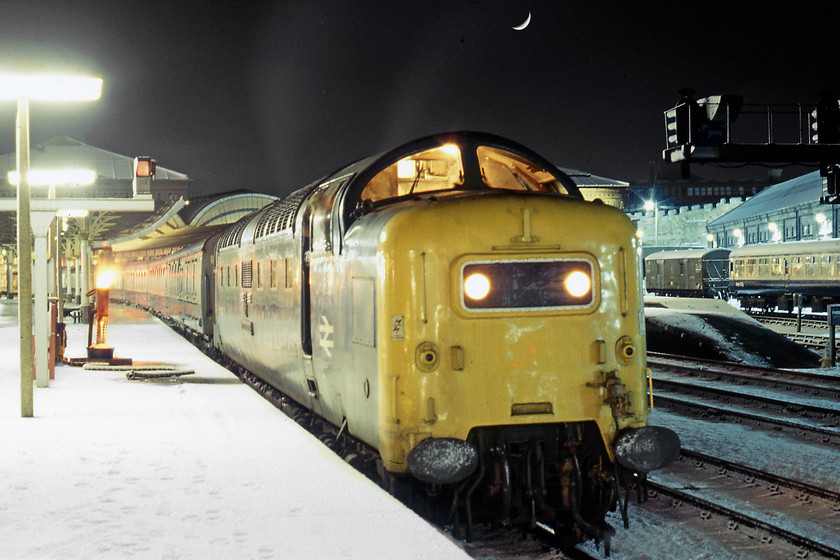 55008, 19.15 Aberdeen-London King's Cross (1E40), York station 
 With the moon overhead, 55008 The Green Howards pauses at York with the 1E40 SO 19.15 Aberdeen-London King's Cross. To the left of the engine note the oil-burning stove to keep the standpipes, used for refilling the steam heat boilers, from freezing up. Notice part of York's world-famous city wall in the background with the former wagon repair works to the far right dating from 1844. The sidings where the coach and the GUV ars stabled is now part of York station's car park. 
 Keywords: 55008 19.15 Aberdeen-London King's Cross 1E40 York station Deltic The Green Howards