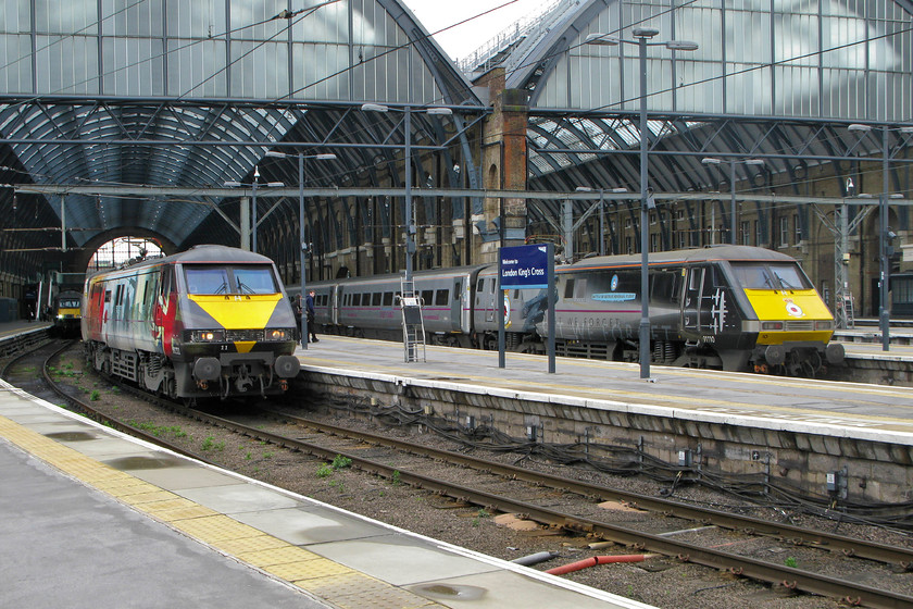 43465, GC 12.53 London King`s Cross-Sunderland (1N93), 91111, GR 13.00 London King`s Cross-Edinburgh (1S18) & 91110, GR, 06.50 Glasgow Central-London King`s Cross (1E06), London King`s Cross station 
 This is a photograph that I could never have planned and one that I will never be likely to replicate showing the two celebrity class 91s standing adjacent to each other at King's Cross. To the left, 91111 'For the Fallen' will work the 1S18 13.00 to Edinburgh whilst to the right, 91110 'Battle of Britain Memorial Flight' has just arrived powering at the rear of the 1E06 06.50 from Glasgow Central. Wherever these locomotives are, they arouse the interest of the public and enthusiasts alike with their dramatic artwork and graphics. To the far left, deep inside the trainshed, Grand Central's HST power car 43465 will soon leave King's Cross with the 1N93 12.53 to Sunderland. 
 Keywords: 43465 12.53 London King`s Cross-Sunderland 1N93 91111 13.00 London King`s Cross-Edinburgh 1S18 91110 06.50 Glasgow Central-London King`s Cross 1E06 London King`s Cross station