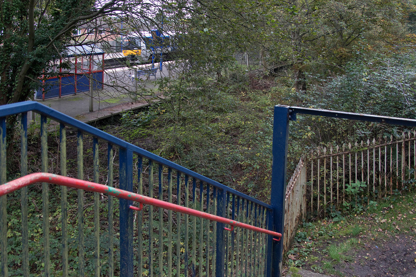 165008, CH 13.34 Birmingham Moor Street-Leamington Spa (2L48, 3L), Lapworth station 
 An unusual picture of 165008 leaving Lapworth station working the 13.34 Birmingham Moor Street to Leamington Spa stopper service. I am standing on the replacement footbridge erected in the 1980s that, as well as spanning the two existing running lines, also spans the abandoned trackbed that can be seen below complete with the old platform still visible. One wonders if the fact that the replacement bridge was built with the extra length at considerable cost that there is a future for the abandoned trackbed? Notice the original GWR railings still marking the boundary between railway property and the public right of way. 
 Keywords: 165008 13.34 Birmingham Moor Street-Leamington Spa 2L48 Lapworth station