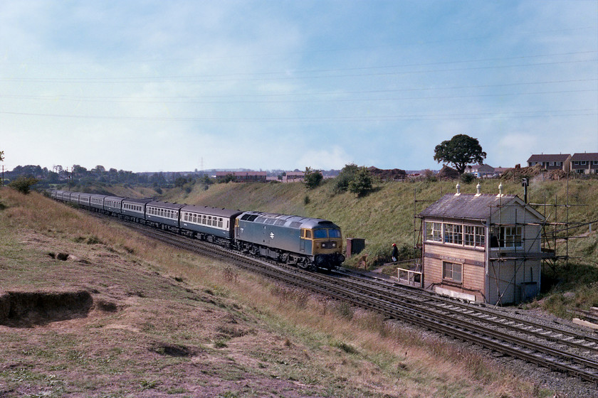 47502, 09.55 Plymouth-Paddington (1A43), Clink Road Junction 
 47502 leads the 1A43 09.55 Plymouth to Paddington past Clink Road Junction on the outskirts of Frome, that can be seen in the background. In fact, the new estate of Berkely Down can be seen under construction immediately behind the signal box above the embankment. Notice the signalman wearing his red helmet waiting to collect his moped as he goes off-shift. 47502 is still with us today as 47715 Haymarket on the Wensleydale Railway in Yorkshire. It was also the subject for a model from various manufacturers such as Bachmann. Being a West Country locomotive, at this time being based at Swansea (Landore), I was a little surprised and disappointed to see it on the MML at Wellingborough in 1980, see.... https://www.ontheupfast.com/p/21936chg/29653198204/x8-47-502-18-00-london-st-pancras hoping for something a little more exotic; if a Class 47 'Duff' could ever have been that? 
 Keywords: 47502 09.55 Plymouth-Paddington 1A43 Clink Road Junction