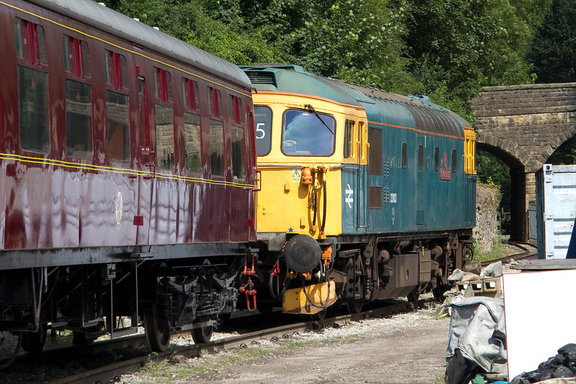 33103, stabled, Wirksworth yard 
 33103 'Swordfish' stands in the summer sun at the north end of Wirksworth yard. It has now been painted back into BR blue following its spell in Fragonset's black lined livery. It's extra high level air pipes, and, out of view, buckeye coupling is testament to the fact that it was one of the Cromptons that was used on the Bournemouth to Weymouth line hauling EMUs before this section of line was electrified. 
 Keywords: 33103 Wirksworth yard