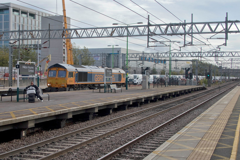 66730, 09.13 Dagenham Dock Reception sidings-Garston Car Terminal (6X43), Milton Keynes Central station 
 Loaded with brand new 'Dagenham Dustbins' of various types, 66730 'Whitemoor' heads north with the 6X43 09.13 Dagenham to Garston train. This particular train was long and heavily loaded and was keeping a significant number of HGVs off the roads. 
 Keywords: 66730 09.13 Dagenham Dock Reception sidings-Garston Car Terminal 6X43 Milton Keynes Central station