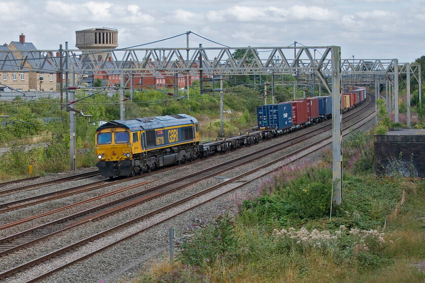 66710, 10.25 Felixstowe South-Trafford Park (4M22, 4L), site of Roade station 
 Namer 1 - 66710 'Phil Packer'

GBRf's 66710 'Phil Packer' passes the site of Roade's former station leading the afternoon's 4M22 10.25 Felixstowe South to Trafford Park service. 
 Keywords: 66710 10.25 Felixstowe South-Trafford Park 4M22 site of Roade station Packer Phil Packer