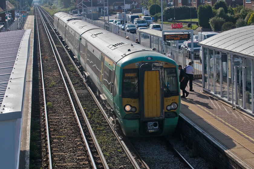 377411, SN 15.29 Portsmouth Harbour-Brighton (1S27, 1E), Lancing station 
 377411 has stopped just stopped at Lancing station working the 15.29 Portsmouth Harbour to Brighton service. Unfortunately, looking into the hot afternoon sun thus making the lighting tricky has not made for the finest photograph. 
 Keywords: 377411 15.29 Portsmouth Harbour-Brighton 1S27 Lancing station Southern Electrostar