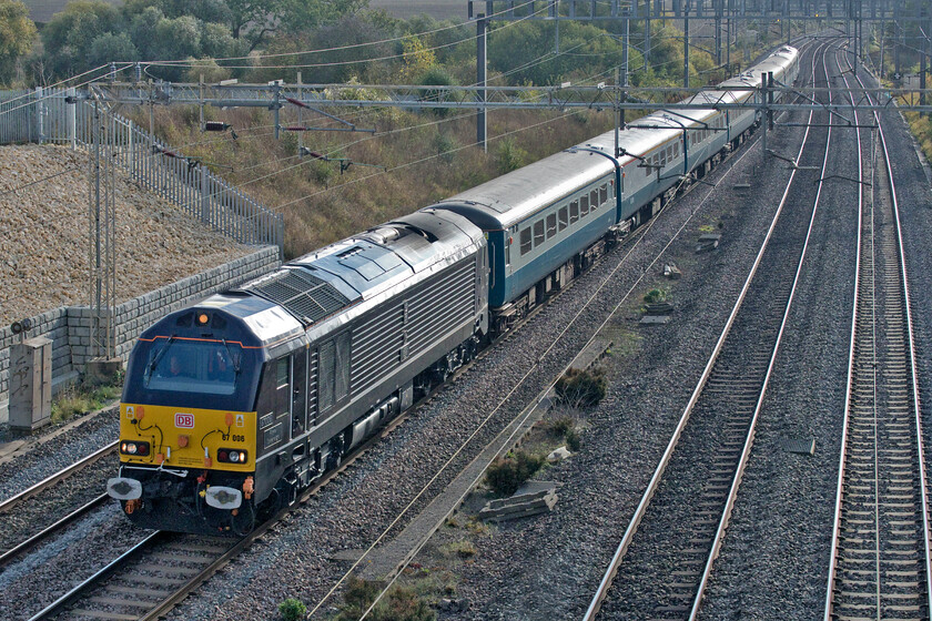 67006 & 67005, 10.18 Db Cargo Fan A & B sidings-Burton Ot Wetmore sidings ECS (5Z71, 1E), Ashton Road bridge 
 Having worked The Yellow Submarine charter on the previous Saturday 67006 'Queen's Messenger' leads the returning empty stock move back to Burton-on-Trent with 67005 'Royal Sovereign' on the rear. Running as the 5Z71 10.18 Db Cargo (Wembley) to Burton ot Wetmore the train is seen approaching Roade on the down slow line. Ironically, the photograph of the ECS working is infinitely better than the one of the actual charter taken two days earlier, see..... https://www.ontheupfast.com/p/21936chg/30021055305/x67006-67005-yellow-submarine-07 
 Keywords: 67006 67005 10.18 Db Cargo Fan A & B sidings-Burton Ot Wetmore sidings ECS 5Z71 Ashton Road bridge Royal Sovereign Queen's Messenger