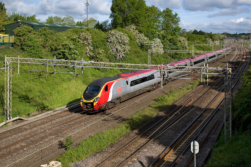 390045, VT 06.35 Manchester Piccadilly-London Euston (1A06), Victoria bridge 
 I have often wondered why so many Pendolinos travel up and down the WCML with their front covers open. It does nothing for their looks and I am sure does not help with their aerodynamics and thus their electricity consumption! Here at Victoria bridge just south of Roade in Northamptonshire 390045 working the 06.35 Manchester Piccadilly to Euston. 
 Keywords: 390045 06.35 Manchester Piccadilly-London Euston 1A06 Victoria bridge Virgin Trains Pendolino