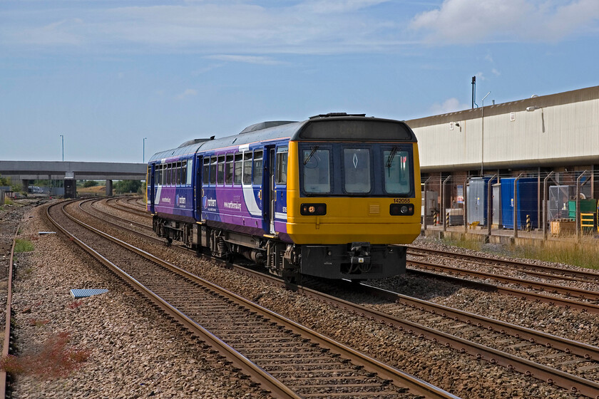 142055, NT 13.44 Blackpool South-Colne, Kirkham SD418327 
 Having just joined from the south 142055 works the 13.44 Blackpool South to Colne service on the approach to Kirkham and Wesham station. The four tracks make for an imposing sight suggesting a lot of traffic and fast express services. Sadly, this is not the case with largely local services to and from Blackpool stations with the odd faster services thrown in operated by TPE and Virgin West Coast. 
 Keywords: 142055 13.44 Blackpool South-Colne Kirkham SD4183277 Northern Pacer