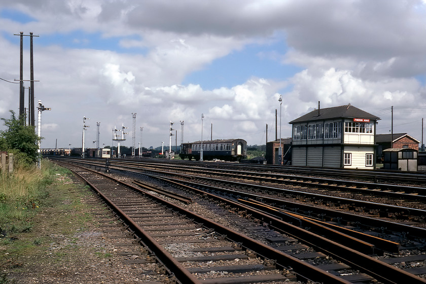 Finedon Road signal box (Mid, 1893) & yard 
 Taken trackside Finedon Road signal box is seen along with part of the extensive yard and sidings. The box is a classic Midland 2B structure dating from 1893 signalled its last train on 05.12.87 with control moving to Leicester PSB. In this view is a vintage Midland bracket signal with two dolls of traditional timber construction. I am not quite sure how Graham and I secured access to this location, we probably clambered across a fence from the adjacent industrial estate that itself occupies the site of Wellingborough's former ironworks. 
 Keywords: Finedon Road Signal Box Midland Railway