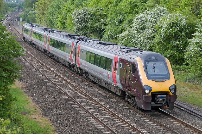 220031, XC 07.45 Bournemouth-Manchester Piccadilly (1M30), Hardwick Farm bridge SP463429 
 Having stopped at Banbury station some mile or so south of this location, CrossCountry Voyager 222031 is accelerating away from the town working the 07.45 Bournemouth to Manchester Piccadilly. There was once a line branching off to the right in this image, disappearing into the greenery, that ran a short distance to Wroxton ironstone quarry. In addition, the Great Central linked to the Great Western at a spot close to the colour light at, what was referred to as, Banbury Junction where their line from Culworth Junction joined. 
 Keywords: 220031 07.45 Bournemouth-Manchester Piccadilly 1M30 Hardwick Farm bridge SP463429 Voyager CrossCountry Trains