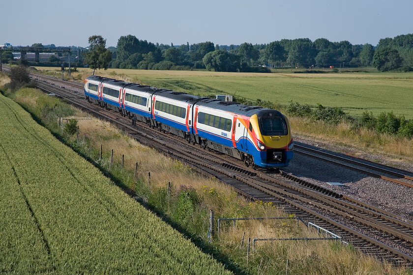 222007, EM 16.35 Sheffield-London St. Pancras, Harrowden Junction 
 Not stopping at Wellingborough, a couple of miles behind me, means that 222007 working the 16.35 Sheffield to St. Pancras service is taking Harroden Junction at full line speed. If the plans come to fruition, this scene is set to change dramatically over the coming years with the route being returned to four tracks seeing a second slow line being reinstated. Also, the line is due to be electrified thus spoiling the unobscured wide vista. However, the start/stop nature of the electrification process may well mean this will not happen for many years yet! 
 Keywords: 222007 16.35 Sheffield-London St. Pancras Harrowden Junction East Midlands Train Meridian