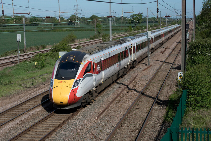 801211, GR 06.00 Berwick-upon-Tweed-London King's Cross (1Y14, 7L), Marholm TF154036 
 From the footbridge at Marholm a short distance north of Peterborough, Azuma 801211 speeds southwards working the 06.00 Berwick-upon-Tweed to King's Cross LNER service. This spot has become a firm favourite with railway enthusiasts and photographers but it loses out on a fair bit of freight that passes tantalisingly close as it takes the much slower and less direct route avoiding the ECML via Spalding, Sleaford, Lincoln and Gainsborough. 
 Keywords: 801211 06.00 Berwick-upon-Tweed-London King's Cross 1Y14 Marholm TF154036 LNER Azuma