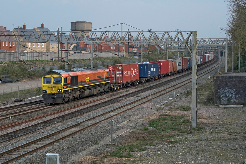 66415, 07.50 Felixstowe North-Lawley Street (4M94, 224L), site of Roade station 
 The 07.50 Felixstowe to Lawley Street is just getting underway after sitting on the down slow line just in sight under the Ashton Road bridge in the distance. It was there for over two hours following the re-opening of the up and down fast lines (nearest the camera). The train was used to shield the view from passing trains of the recovery and investigations following the horrible death of a track worker hit by 2N30 earlier in the morning. 66415 'You Are Never Alone' gets the heavy train going to be followed by the handing back of the down slow to signalers. The up slow opened sometime later once 2N30 was moved away from the scene. This awful incident reminds us again how dangerous railways are. This appeared to be a well-managed worksite and I am sure that the protocols and safety cases were all followed and in place and yet, still a worker was tragically hit and killed by a train. My thoughts are with all those involved with this tragedy. 
 Keywords: 66415 07.50 Felixstowe North-Lawley Street 4M94 site of Roade station You Are Never Alone Freightliner