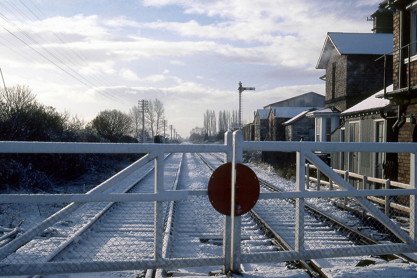 Looking towards York, Haxby level crossing 
 Looking south-west towards York from Haxby level crossing with the former signal box just in view to the right. In this view, it looks as of there has been a train heading towards Scarborough (the right track) but nothing from that direction given the track still with a coating of snow. There was a station at Haxby that was closed very early in 1930, indeed, the former station building can also be seen just beyond the signal box. There is continued talk of the reopening of a station at Haxby in an effort to help ease the chronic traffic congestion within the city of York. 
 Keywords: Looking towards York Haxby level crossing