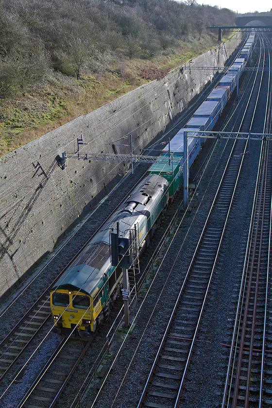 66502, 11.24 Felixstowe North-Lawlwy Street (4M94), Roade cutting 
 The 11.24 Felixstowe to Lawley Street Freightliner makes its way through Roade cutting led by 66502 'Basford Hall Centenary 2001'. I like the lighting in this photograph despite it breaking the rules by being strongly side-lit with Photoshop being fully utilised to bring out the detail in the deep shadows. 
 Keywords: 66502 11.24 Felixstowe North-Lawley Street 4M94 Roade cutting Basford Hall Centenary 2001