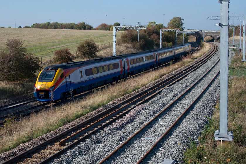 222018, EM 12.00 Sheffield-London St. Pancras (1C42, 48L), Irchester SP927667 
 222018 sweeps around the curve at Irchester as it commences the climb to Sharnbrook summit working the very late 12.00 Sheffield to St. Pancras. This service left Sheffield on-time but something went wrong in the Chesterfield area and by Derby it was even worse. It eventually arrived into St. Pancras some 48 minutes late. In the image the fresh ballast of the recently reinstated up slow line can be seen as well as some of newly installed electrification masts. 
 Keywords: 222018 12.00 Sheffield-London St. Pancras 1C42 Irchester SP927667