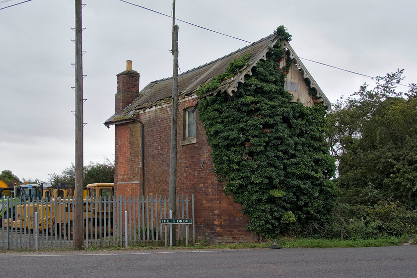 Former Postland signal box (GN, 1882) 
 With ivy slowly enveloping Postland signal box it is fast disappearing from view from this end at least! The box was shut in 1982 when the former GN & GE Joint line from March to Spalding was finally closed. It is remarkable that it still survives in its original state but its condition is decidedly parlous! 
 Keywords: Former Postland signal box GN 1882