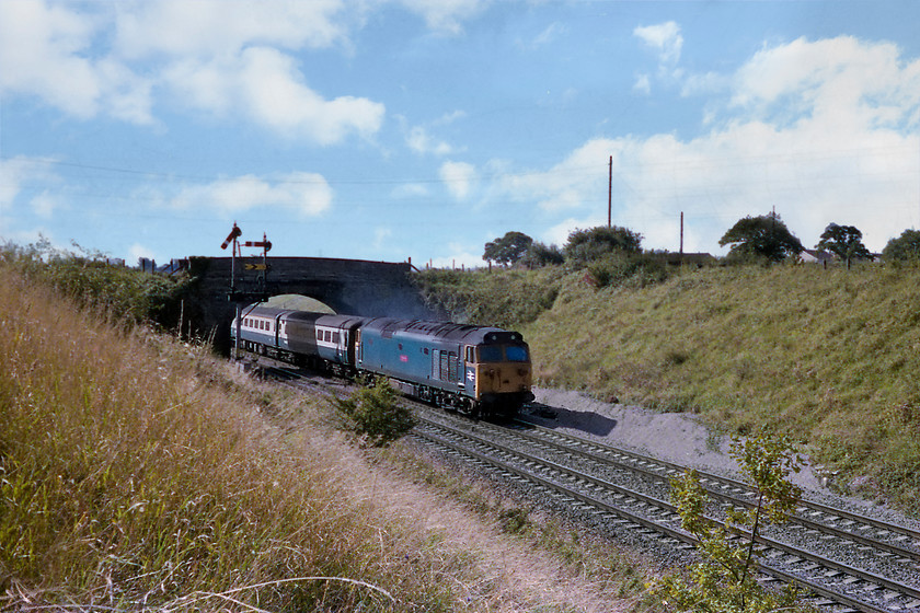 50017, unidentified up working, Clink Road Junction 
 50017 Royal Oak heads towards London Paddington with an up service past Clink Road Junction on the outskirts of Frome. The down main and down Frome line signals are clearly in view. The taller post is the one for the cut-off indicating that it is the more important route. The lovely road bridge, typical of the Great Western, is built out of stone has sadly now been demolished and replaced by a much larger and higher concrete structure constructed when the Frome bypass was built in the 1990s. 
 Keywords: 50017 up working Clink Road Junction