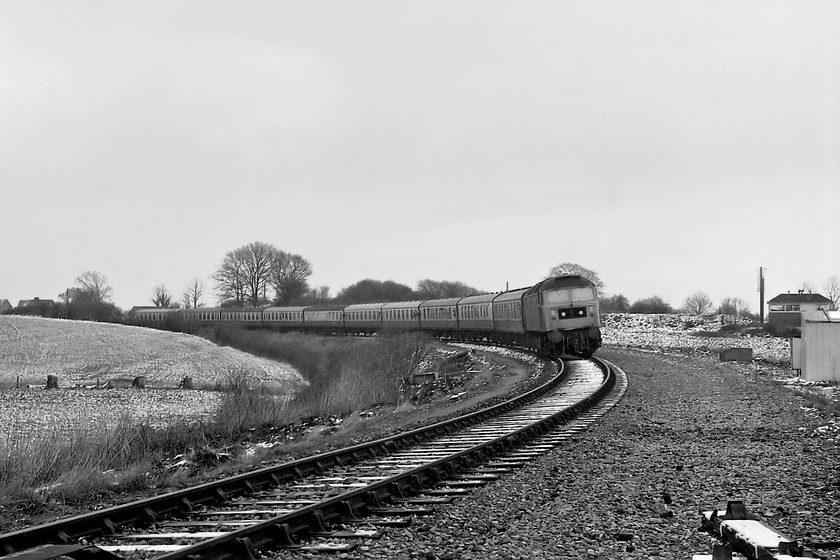 47069, outward leg of The Pines Express, 07.48 London Paddington-Weymouth (via Bristol & various freight lines), Bradford North Junction 
 47069 creeps round Bradford North Junction's rarely used spur as it comes to a halt for the exchange of the single-line token that the train will have collected at Thingley Junction just west of Chippenham. The 47 is hauling the very late running Pines Express that was taking in some rare West Country track. However, things had already started to go very wrong, this was the fourth locomotive that had hauled the train and this was not by design! Also, none of the locomotives had any heating capability so the passengers would have to be cuddling up to keep warm! 
 Keywords: 47069 The Pines Express 07.48 London Paddington-Weymouth Bradford North Junction