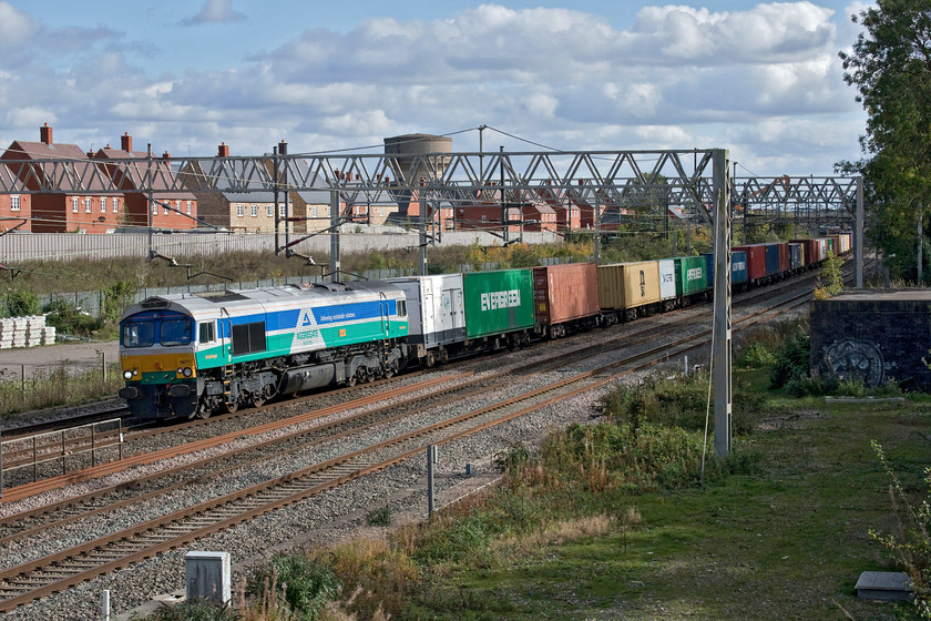 66711, 10.36 Felixstowe North-Hams Hall (4M23, 4L), site of Roade station 
 Peering through the viewfinder as the train approached from the distance I could see that it was one of those wearing a celebrity livery but could not work out which one until it was much closer. Hoping that it would be one of those that I needed a photograph of I was a little disappointed that it was 66711 'Sence' that I have seen a number of times. However, wearing its GBRf - Aggregate Industries paint scheme is always something different from the more normal Freightliner and DRS locomotives that roll past through Roade all day long! It was leading the 4M23 10.36 Felixstowe to Hams Hall service. 
 Keywords: 66711 10.36 Felixstowe North-Hams Hall 4M23 site of Roade station Sence