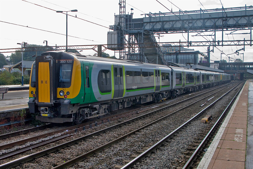 350120, for LM 08.54 Birmingham New Street-London Euston (2Y02) & 350102, LM 08.33 Birmingham New Street-London Euston (1W06), Northampton station 
 Under Northampton's, thankfully temporary, footbridge 350120 is about to join 350102 with both units then working forward to Euston. London Midland operate a lot of 'cut and shut' services that split and join at Northampton. It only needs one of these services to be a little late for the planned arranagemnts to go wrong! 
 Keywords: 350120 08.54 Birmingham New Street-London Euston 2Y02 350102 08.33 Birmingham New Street-London Euston 1W06 Northampton station London Midland Desiro