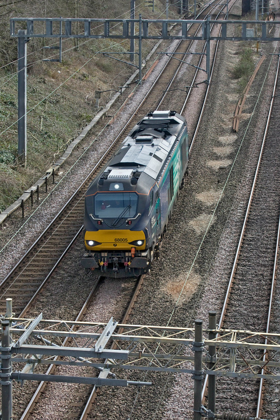 68005, 09.35 Wembley-Crewe Gresty Bridge (0K69, 77E), Hyde Road bridge 
 68005 'Defiant' passes through Roade about to go under the village's Hyde Road Bridge with the 09.35 Wembley to Crewe Gresty Bridge light engine move. These Vossloh Espaa constructed locomotives are very noisy. Despite this one operating as a light engine I could hear it, even running under relatively low power, sometime before it came into view. 
 Keywords: 68005 09.35 Wembley-Crewe Gresty Bridge 0K69 Hyde Road bridge DRS Defiant Direct Rail Services