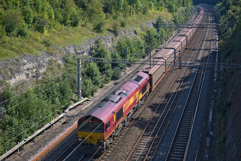 66047, 09.05 Southampton Eastern Docks-Halewood (6M38), Roade cutting 
 Another diversion due to the closure of the Oxford to Banbury route that is not seen that often is the 6M38 09.05 Southampton Docks to Halewood empty cartics. On this Sunday it is seen off-route on the WCML being lead by EWS liveried 66047 on this glorious early autumn afternoon. 
 Keywords: 66047 09.05 Southampton Eastern Docks-Halewood 6M38 Roade cutting EWS