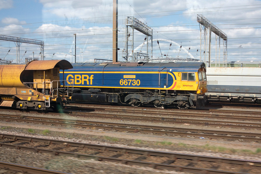 66730, stabled, Wembley Yard 
 With the Wembley stadium arch in the background, this can only be Wembley Yard! 66730 'Whitemoor' awaits its next turn of duty. The 66 was named after the huge PW yard that has been developed on the site of the old depot and marshalling yard in November 2011. 
 Keywords: 66730 stabled Wembley Yard