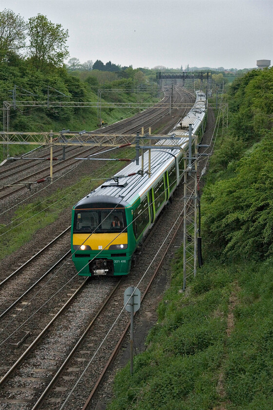 321416, unidentified up working, Victoria bridge 
 London Midalnd's 321416 leads two other sets on an up commuter service past Roade. These units have been on these lines for twenty-four years now and have proved to be extremely reliable but their time is up with them now just being used on a few peak services as here with the Class 350s operating the vast majority of trains. 
 Keywords: 321416 unidentified up working Victoria bridge London Midland dusty bin