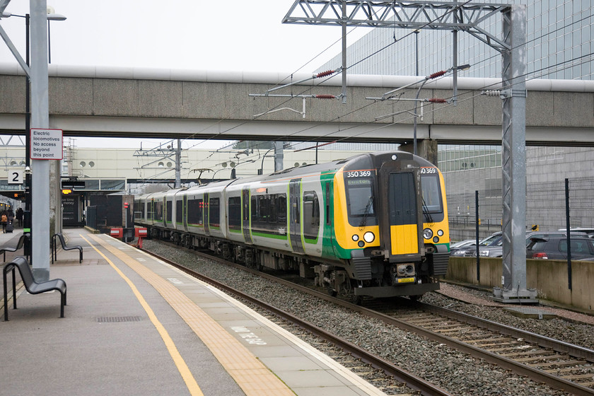 350369, LM 08.54 Birmingham New Street-London Euston (2Y02), Milton Keyes Central station 
 350369 leaves platform 1 at Milton Keynes forming the 2Y02 08.54 Birmingham New Street to Euston. As it's designated as a '2' service indicates that its one of the slower stopper workings, ones that my wife and I try to avoid using for our frequent trips to London. 
 Keywords: 350369 08.54 Birmingham New Street-London Euston 2Y02 Milton Keyes Central station