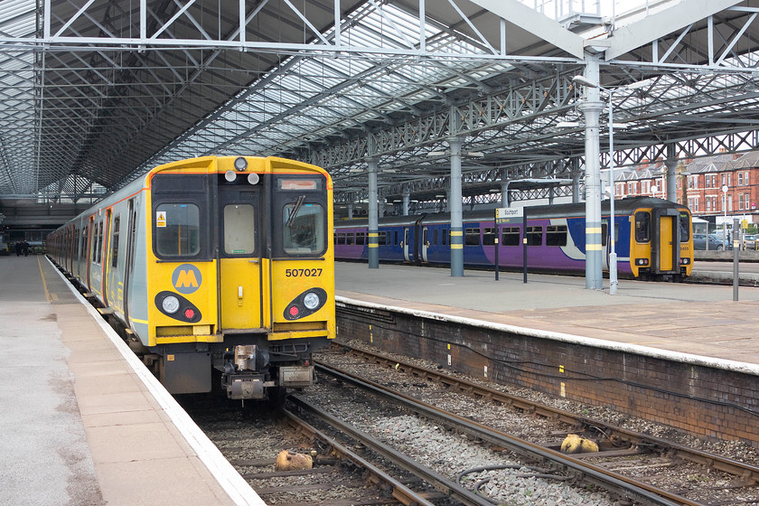 507027, MR 15.58 Southport-Hunts Cross (2U38) & 156455, NT 15.23 Southport-Manchester Airport (2U38), Southport station 
 Southport station is an impressive terminus serving the popular seaside town. Even though it has experienced considerable rationalisation losing some of its excursion platforms at the far side, it still sees regular services to Manchester and to Merseyside. 507027 waits at platform two with the 15.58 to Hunt's Cross whilst 156455 will leave from platform four with the 15.23 to manchester Airport. 
 Keywords: 507027 15.58 Southport-Hunt's Cross 2U38 156455 15.23 Southport-Manchester Airport 2U38 Southport station