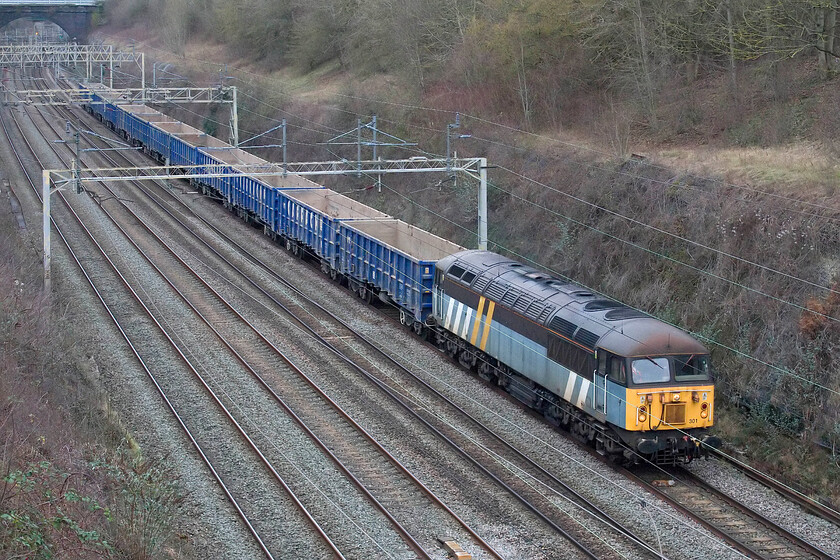 56301, 07.44 Chaddesden Sidings-Acton TC (4Z43, 17E), Hyde Road bridge 
 56301 is the only remaining locomotive wearing the livery of the defunct freight operator Fastline. The company went into administration as part of the Jarvis debacle in 2010 so the paint scheme predates that. Currently leased to DCR and soon to be owned outright by them 56301 is seen passing through Roade taken from the village's Hyde Road bridge leading the 4Z43 07.44 Chaddesden Sidings (Derby) to Acton empty JNA wagons presumably for HS2 work. 
 Keywords: 56301 07.44 Chaddesden Sidings-Acton TC 4Z43 Hyde Road bridge DCR Fastline