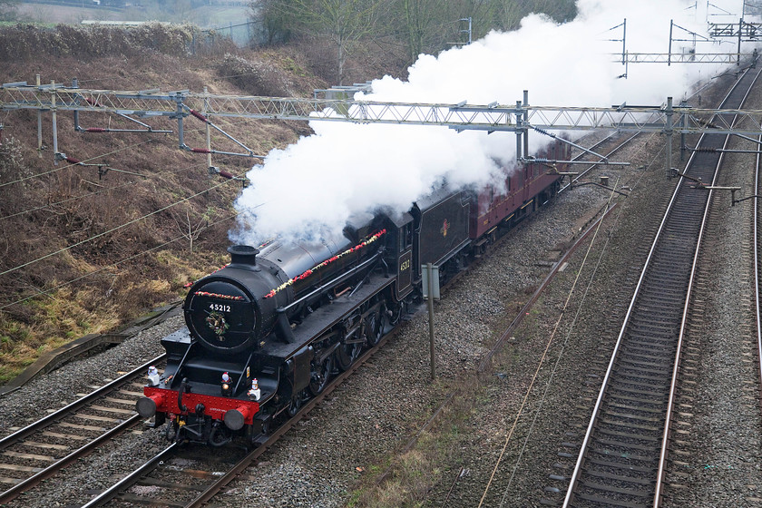 45212, 09.50 Southall-Castleton (5Z43), Victoria Bridge 
 Stanier Black 5 4-6-0 number 45212 is suitably adorned with tinsel as it passes Victoria Bridge between Roade and Hanslope Junction in Northamptonshire. It was making a positioning 5Z43 LE move with one support coach as the 09.50 Southall to Castleton in Rochdale. Here it will reverse and join the East Lancs. Railway at Castleton Junction. 
 Keywords: 45212 09.50 Southall-Castleton 5Z43 Victoria Bridge