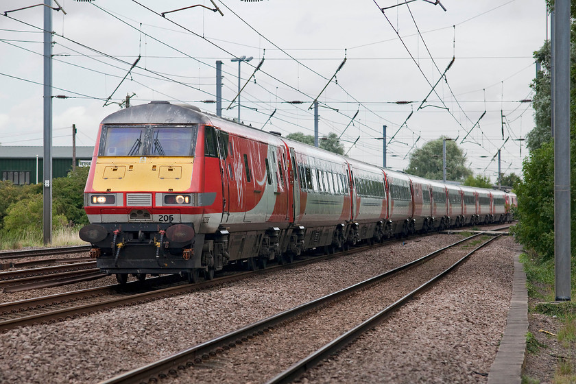 82206 & 91116, GR 06.55 Skipton-London Kings Cross (1A13, RT), Gills Crossing 
 With 82206 on the front and 91116 pushing at the rear working the 06.55 Skipton to London King's Cross. This would be a very nice way to travel from the Aire Valley to London, the comfort of the Mk.IVs is superb and there is a general air of quality about them. Surely, loco hauled stock on fast crack express' such as these has to be the way to go? 
 Keywords: 82206 91116 1A13 Gills Crossing